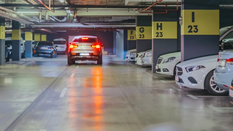Underground Parking lot. Row of colorful parked cars in underground parking structure with numbered zones. Concept of city planning, transportation, structured mobility